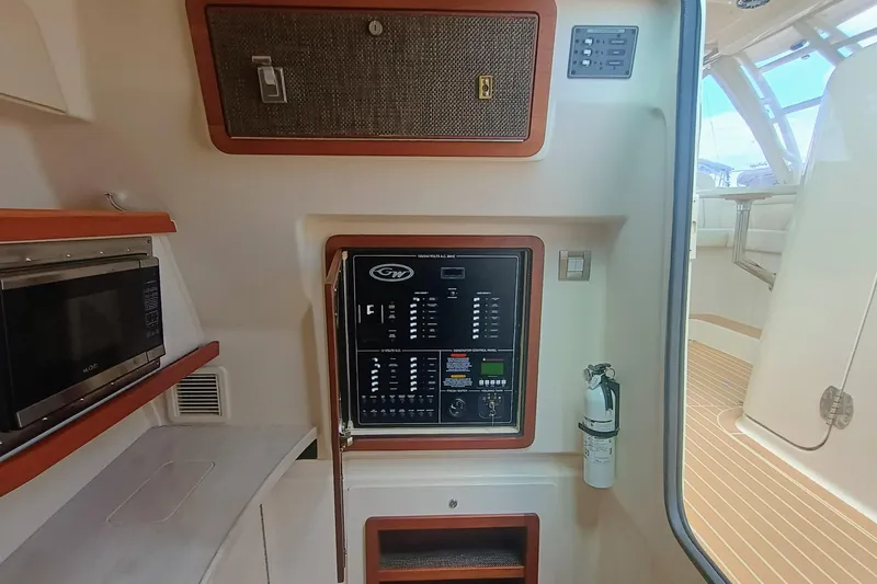 335-712 Used Yacht Photos Pics 2021 Grady-White Freedom 375 interior with control panel, microwave, and fire extinguisher.