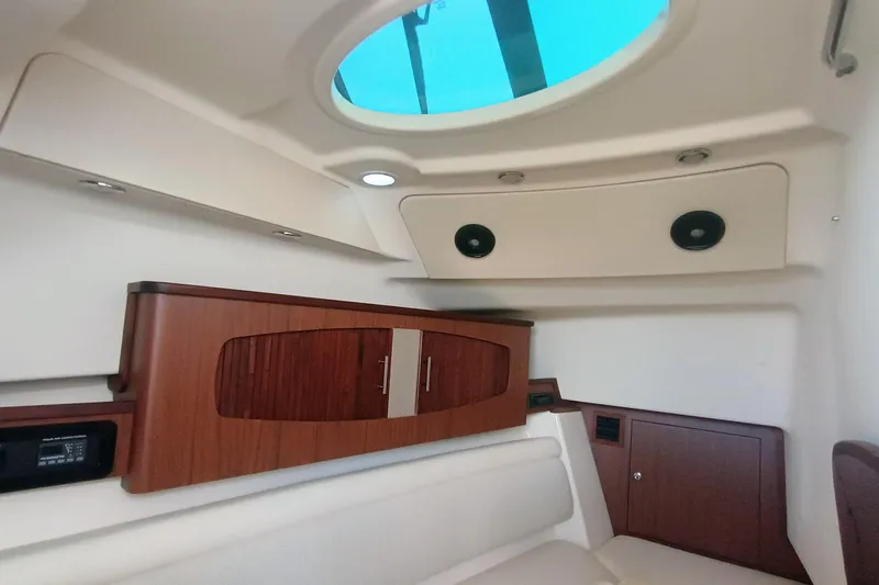 335-712 Used Yacht Photos Pics 2021 Grady-White Freedom 375 cabin interior with wood cabinetry and skylight.