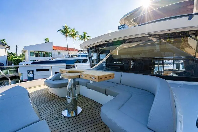  Yacht Photos Pics Luxurious 2022 Absolute 64 Navetta yacht with elegant outdoor seating and table.