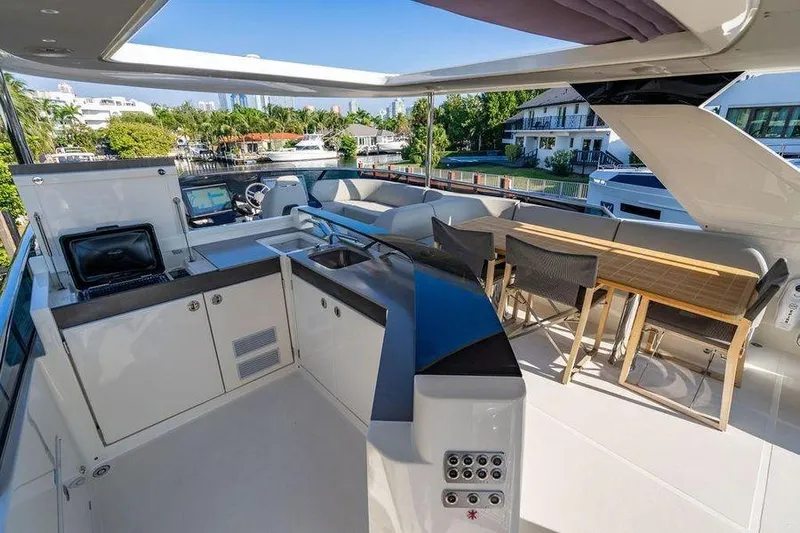  Yacht Photos Pics Luxurious 2022 Absolute 64 Navetta yacht deck with modern kitchen and dining area.