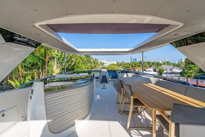  Yacht Photos Pics Luxurious 2022 Absolute 64 Navetta yacht deck with seating and scenic view.