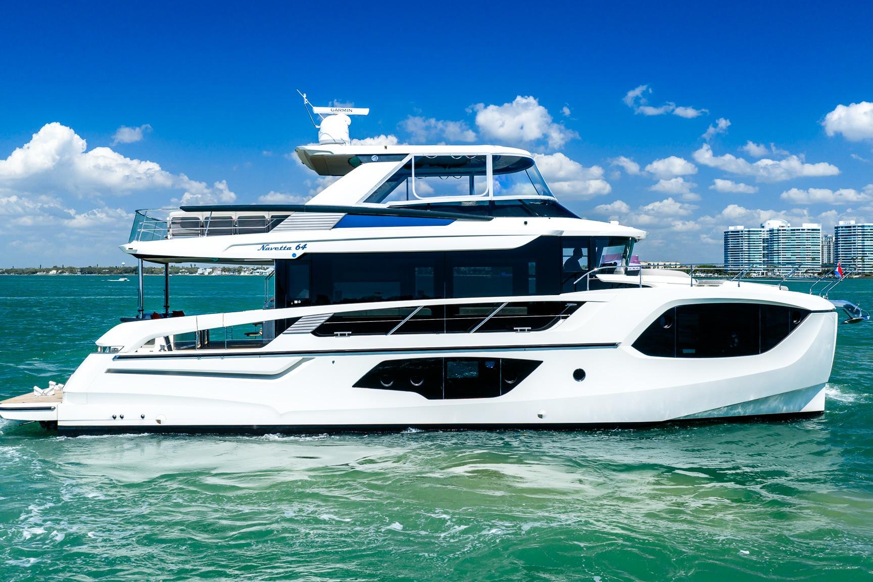 Luxury 2022 Absolute 64 Navetta yacht cruising on clear blue waters.