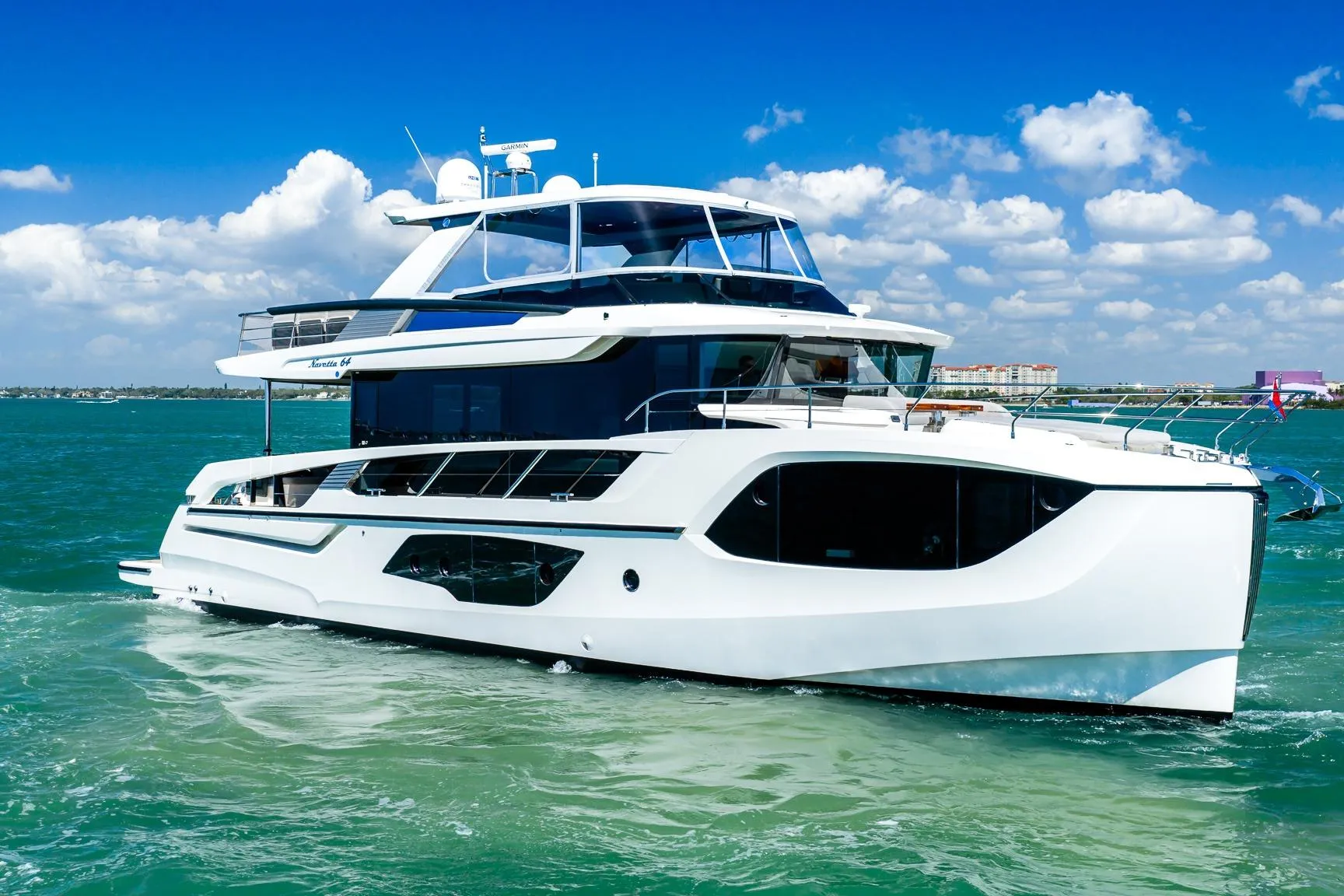Luxury yacht Absolute 64 Navetta 2022 cruising on turquoise waters under a clear blue sky.
