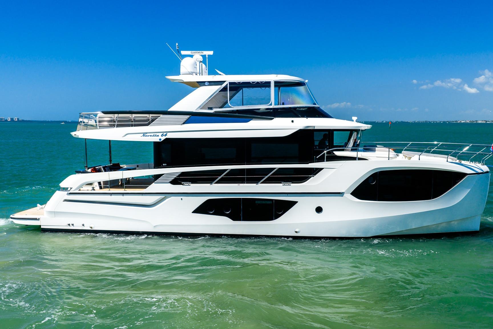 Luxury Absolute 64 Navetta yacht cruising on clear blue waters, 2022 model.