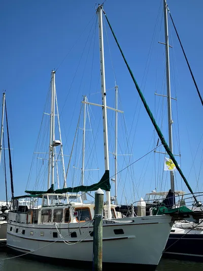 Whiskey River Yacht Photos Pics 1981 Island Trader 46 sailboat docked at marina under clear blue sky.