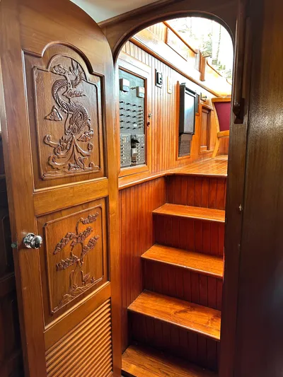 Whiskey River Yacht Photos Pics Interior of 1981 Island Trader 46 yacht with carved wooden door and staircase.