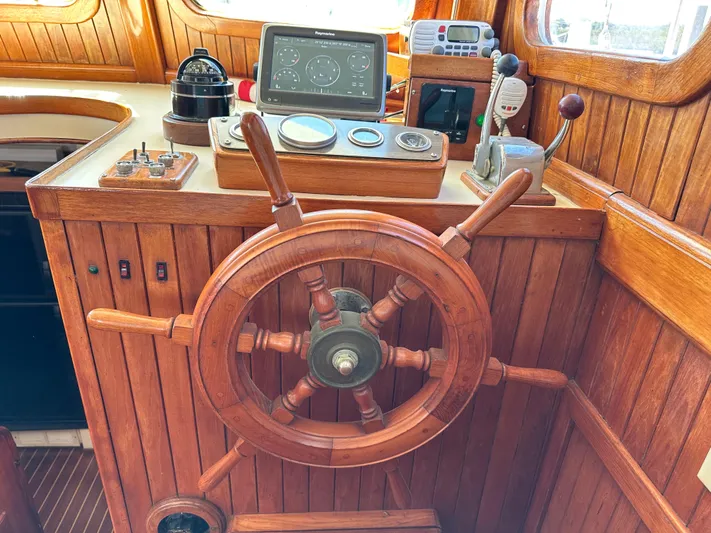 Whiskey River Yacht Photos Pics Wooden helm of 1981 Island Trader 46 sailboat with navigation instruments.