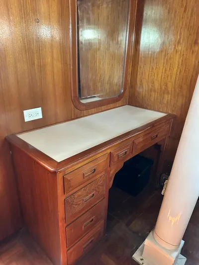 Whiskey River Yacht Photos Pics Wooden vanity with mirror on 1981 Island Trader 46 yacht, featuring drawers and classic design.