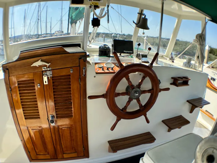 Whiskey River Yacht Photos Pics 1981 Island Trader 46 sailboat helm with wooden wheel and navigation instruments.