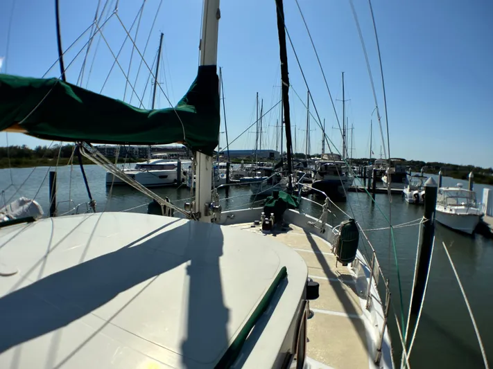 Whiskey River Yacht Photos Pics Sailboat docked in marina, Island Trader 46, 1981 model, sunny day, calm waters.