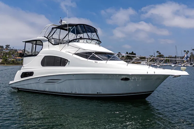 At Ease Yacht Photos Pics 2004 Silverton 39 Motor Yacht on calm water under a clear blue sky.