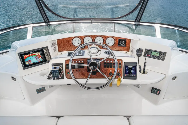 At Ease Yacht Photos Pics Cockpit of 2004 Silverton 39 Motor Yacht with navigation instruments and steering wheel.