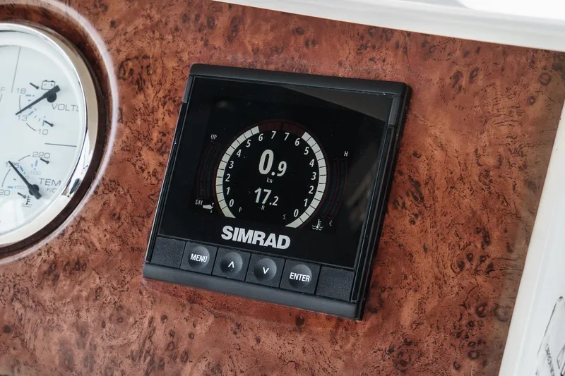 At Ease Yacht Photos Pics Simrad display on 2004 Silverton 39 Motor Yacht dashboard, featuring navigation controls.
