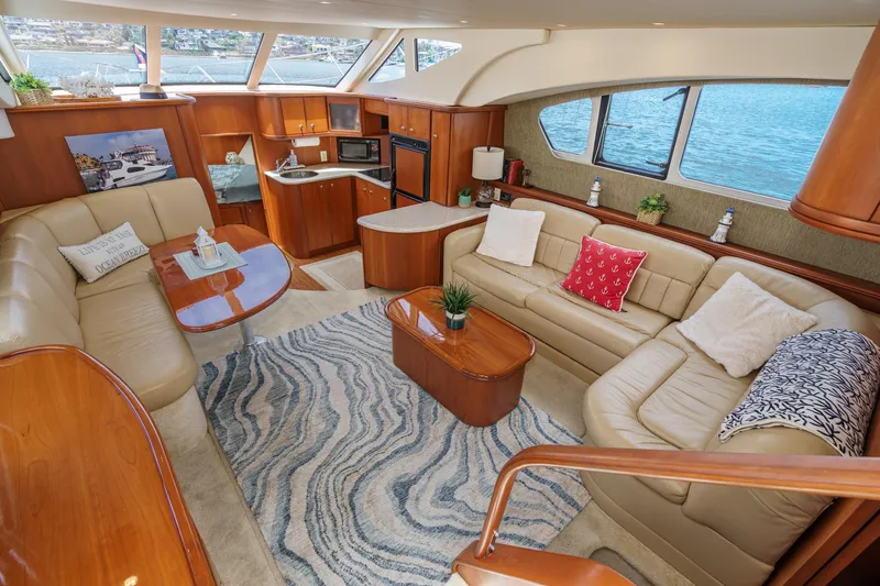 At Ease Yacht Photos Pics Luxurious interior of 2004 Silverton 39 Motor Yacht with elegant seating and scenic windows.