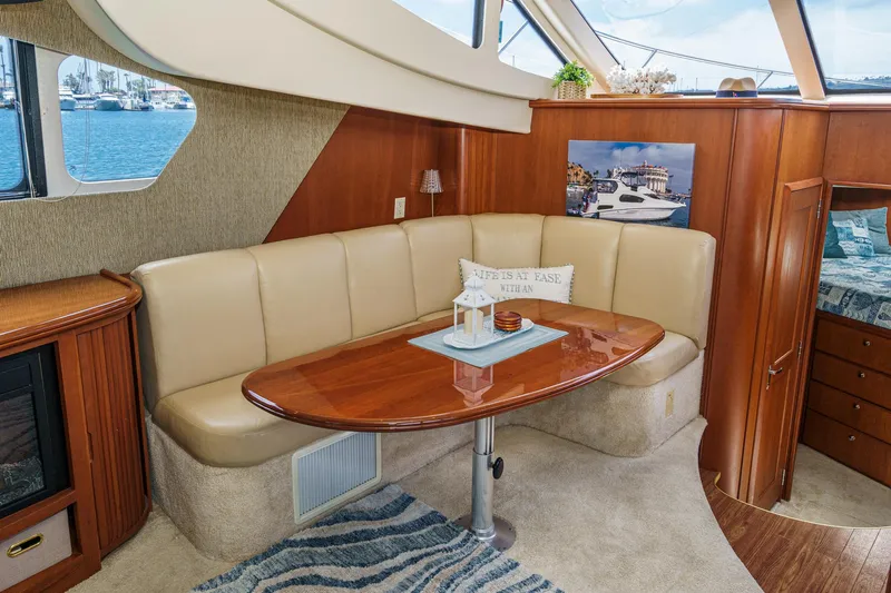 At Ease Yacht Photos Pics Luxurious interior of 2004 Silverton 39 Motor Yacht with elegant seating and wooden table.