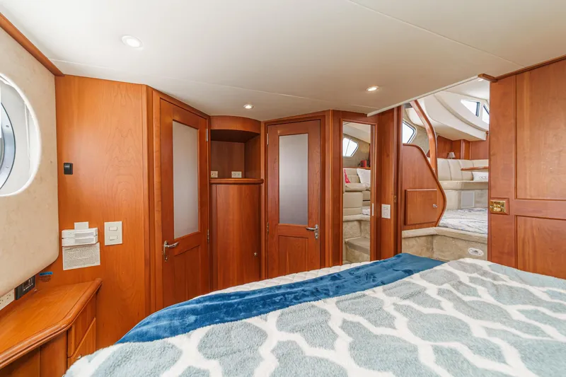 At Ease Yacht Photos Pics 2004 Silverton 39 Motor Yacht interior with wood paneling and cozy bedroom.