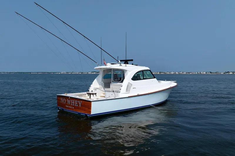 No Whey Yacht Photos Pics 2023 Henriques 42 Express Hardtop boat on calm water, clear sky background.
