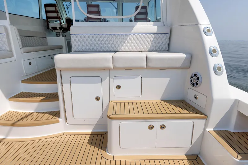 No Whey Yacht Photos Pics 2023 Henriques 42 Express Hardtop boat interior with cushioned seating and teak flooring.