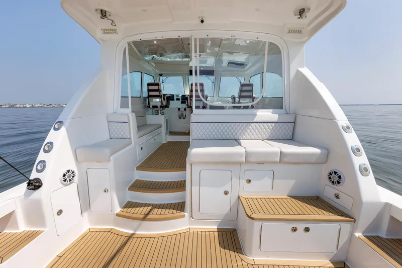 No Whey Yacht Photos Pics 2023 Henriques 42 Express Hardtop boat interior with seating and wooden flooring.