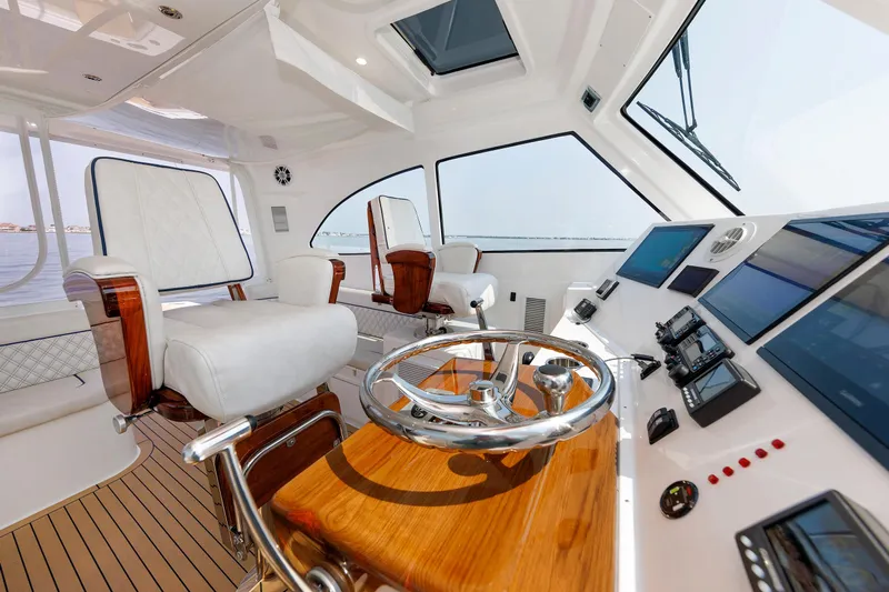 No Whey Yacht Photos Pics Luxurious interior of 2023 Henriques 42 Express Hardtop yacht with modern helm and seating.