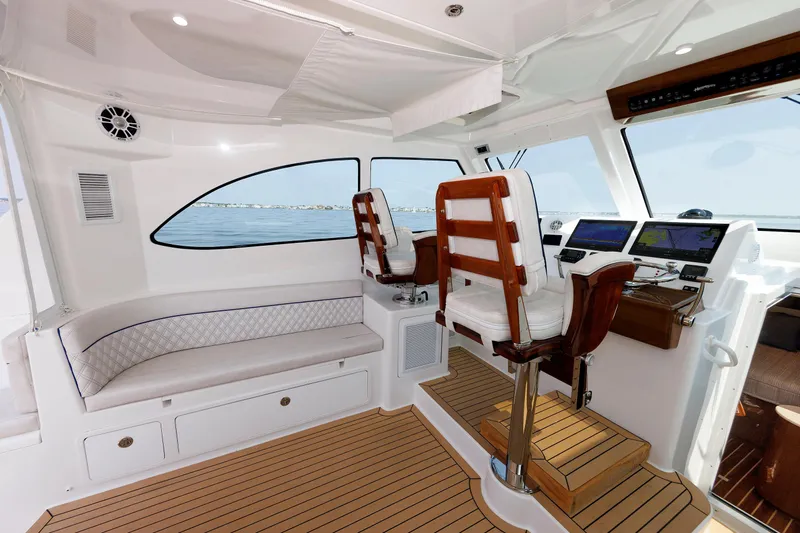 No Whey Yacht Photos Pics 2023 Henriques 42 Express Hardtop interior with helm, seating, and navigation displays.