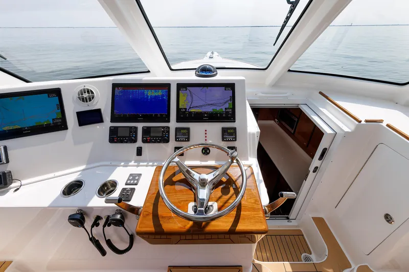 No Whey Yacht Photos Pics 2023 Henriques 42 Express Hardtop helm with advanced navigation displays and wooden steering wheel.