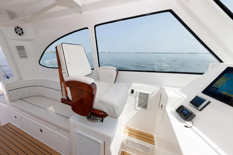 No Whey Yacht Photos Pics 2023 Henriques 42 Express Hardtop interior with helm seat and navigation display.