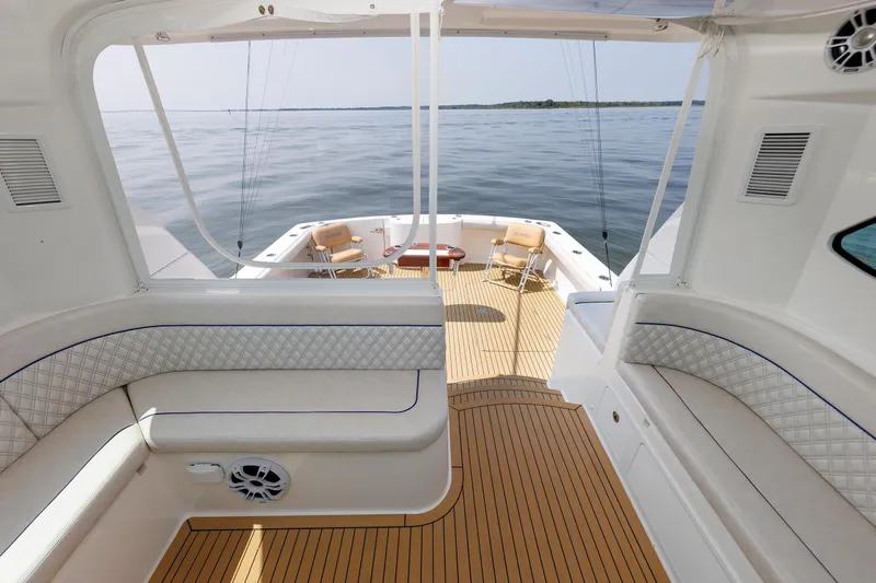 No Whey Yacht Photos Pics 2023 Henriques 42 Express Hardtop boat interior with seating and ocean view.