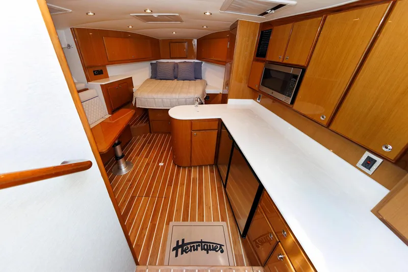 No Whey Yacht Photos Pics Interior of 2023 Henriques 42 Express Hardtop with wood cabinetry and modern amenities.
