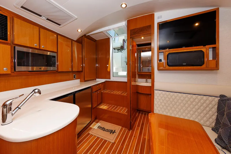 No Whey Yacht Photos Pics Luxurious interior of 2023 Henriques 42 Express Hardtop yacht with modern kitchen and seating area.