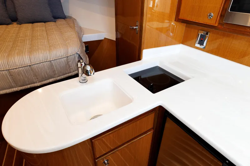 No Whey Yacht Photos Pics 2023 Henriques 42 Express Hardtop interior with modern kitchen and cozy sleeping area.