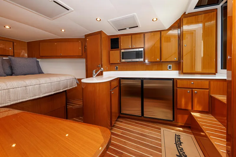 No Whey Yacht Photos Pics Luxurious interior of 2023 Henriques 42 Express Hardtop yacht with wood finish and modern amenities.