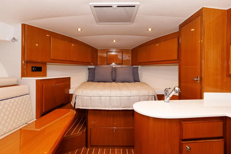 No Whey Yacht Photos Pics 2023 Henriques 42 Express Hardtop cabin interior with wood finish and cozy bed.
