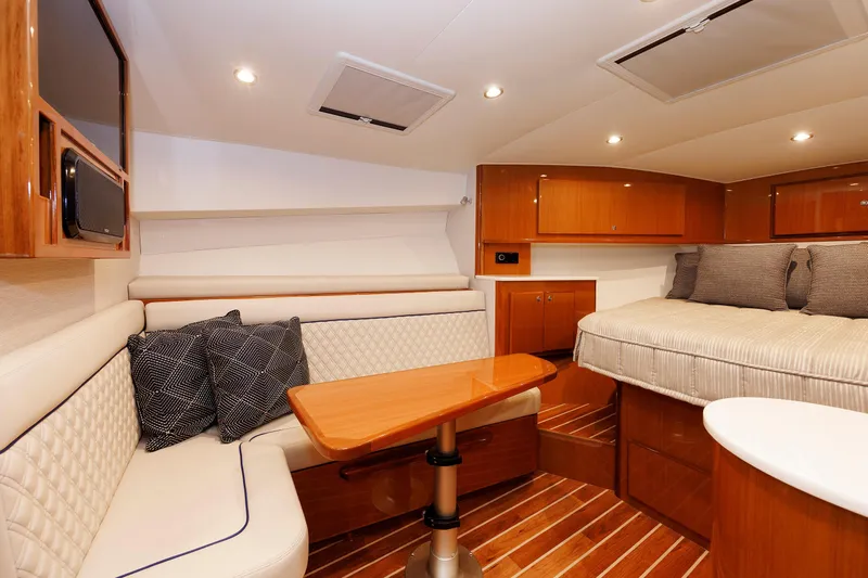 No Whey Yacht Photos Pics 2023 Henriques 42 Express Hardtop interior with cozy seating and elegant wood finishes.