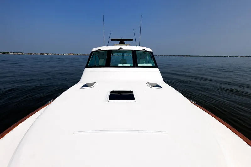 No Whey Yacht Photos Pics 2023 Henriques 42 Express Hardtop boat on calm water, clear sky background.