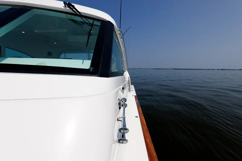 No Whey Yacht Photos Pics 2023 Henriques 42 Express Hardtop yacht cruising on calm waters under clear blue sky.
