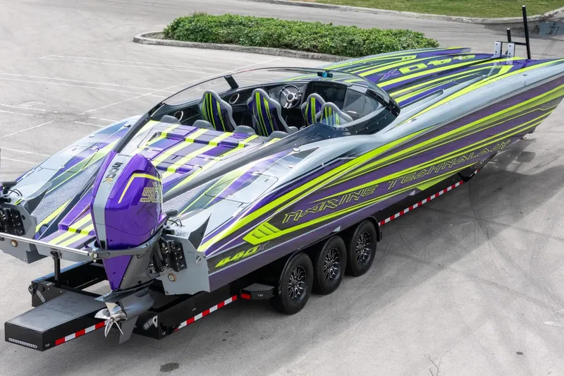  Yacht Photos Pics 2024 MTI 440X powerboat with vibrant purple and green design on a trailer.