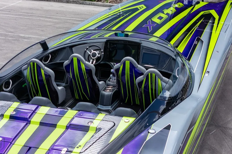  Yacht Photos Pics 2024 MTI 440X speedboat with vibrant green and purple design, featuring sleek seating and modern dashboard.
