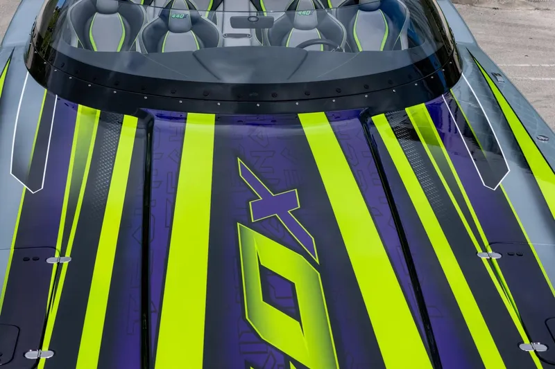  Yacht Photos Pics 2024 MTI 440X boat with vibrant green and purple racing stripes.