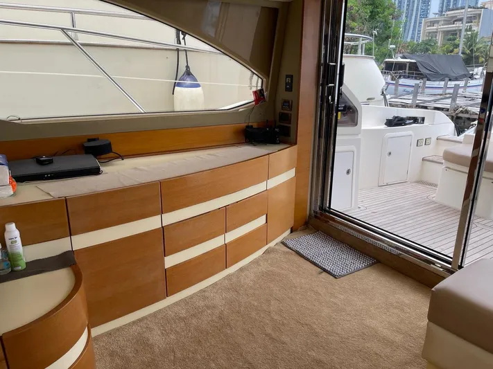 Obsession Yacht Photos Pics Interior of 2012 Azimut 53 yacht with wooden cabinetry and open deck view.
