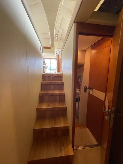 Obsession Yacht Photos Pics Interior view of 2012 Azimut 53 yacht, featuring wooden stairs and modern design.