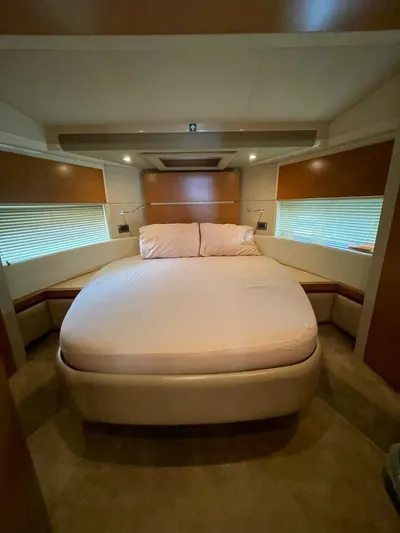 Obsession Yacht Photos Pics Luxurious bedroom interior of a 2012 Azimut 53 yacht with a cozy bed.