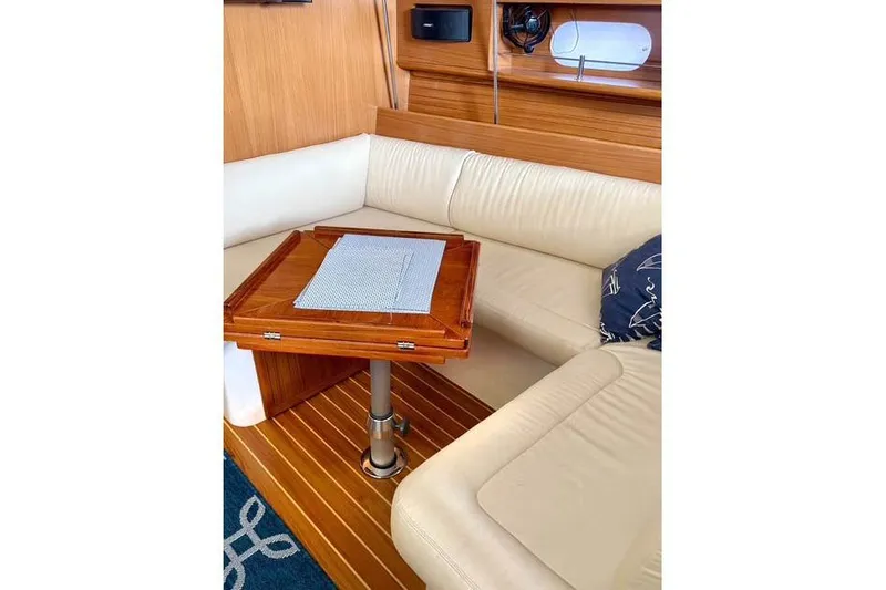 Falken Yacht Photos Pics 2017 Catalina yacht interior with wooden table and cream leather seating.