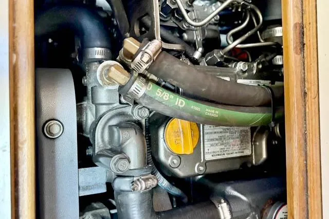 Falken Yacht Photos Pics Engine compartment of a 2017 Catalina boat, showcasing hoses and mechanical components.