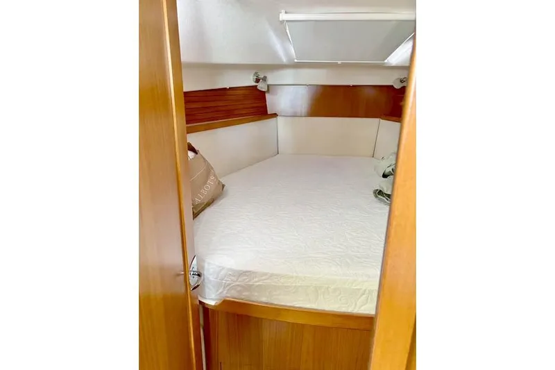 Falken Yacht Photos Pics 2017 Catalina boat cabin with cozy bed and wooden interior.