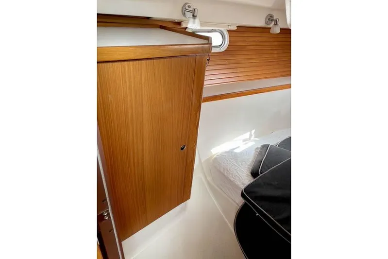 Falken Yacht Photos Pics 2017 Catalina boat interior with wooden cabinet and cozy sleeping area.