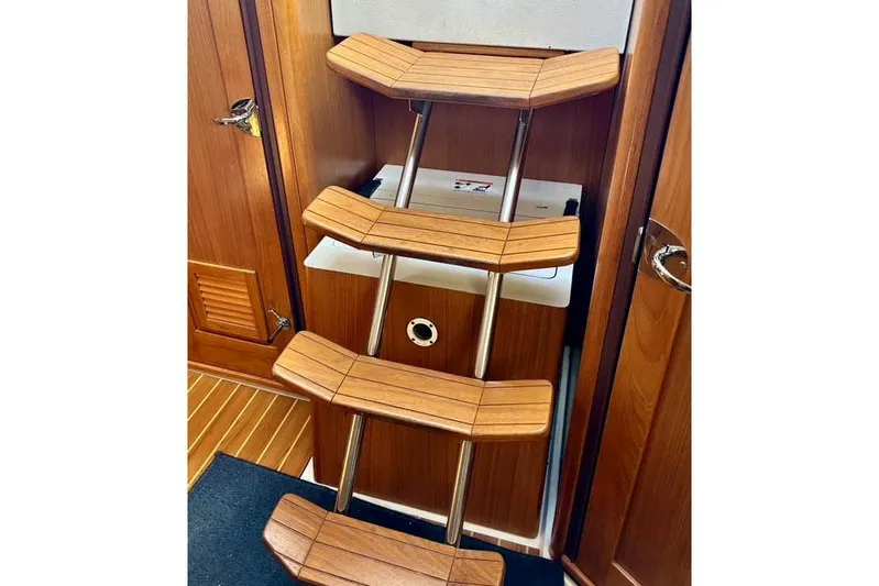 Falken Yacht Photos Pics Wooden interior stairs on a 2017 Catalina boat, featuring sleek metal supports.