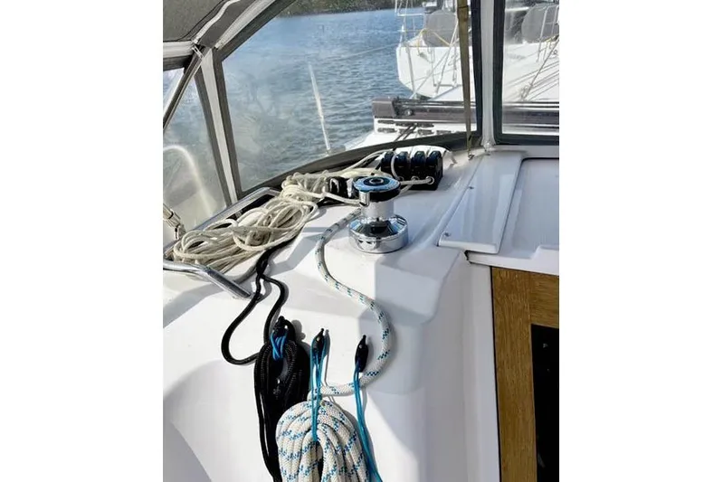 Falken Yacht Photos Pics 2017 Catalina sailboat cockpit with ropes and winch, overlooking calm water.