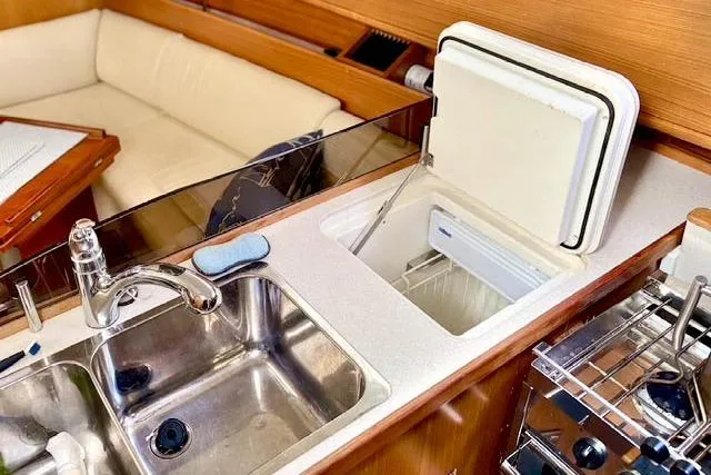 Falken Yacht Photos Pics 2017 Catalina yacht kitchen with sink, fridge, and seating area.