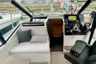  Yacht Photos Pics 2024 Jeanneau Merry Fisher 895 interior with helm, seating, and navigation equipment.